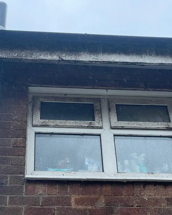 Dirty black fascia and windows before cleaning